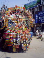 One of Pakistan's customised, colourful buses. Believe it or not, this is the front, not the back, the tiny bit of clear glass visible is all the driver has to see out!