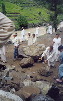 On our way back down we were stopped twice by rockslides, this one took two days to clear. The people making cursory & innefective attempts to clear the boulders are other drivers.