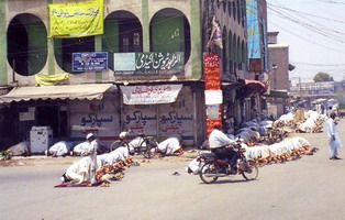 Men caught in the street when the muezin called to prayer.