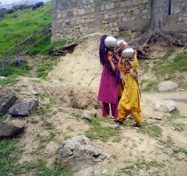 Little girls carrying water down from a spring in the foothills of the Hindukush.