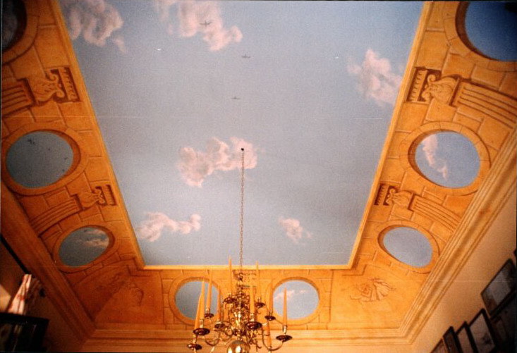 Mural: Baron & Baroness Cristoff Von Pfetten, in the formal dining room. In the centre hangs a fine 17th century Dutch candelabra & around the tops of the walls can be glimpsed the frames from Baroness Bettina's collection of menus signed by important men at historical gatherings in restaurants from around the world. 