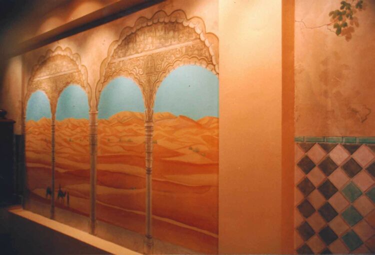 Mural: Beside the tile mural a view from the arches of the Alhambra of the Sahara desert crossed by bedouins.