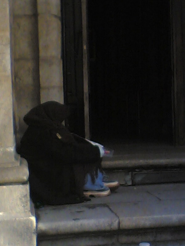 Beggar on the church steps